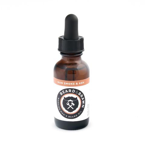beard and brawn beard oil in amber bottle with dropper.  Gun smoke and ash scent